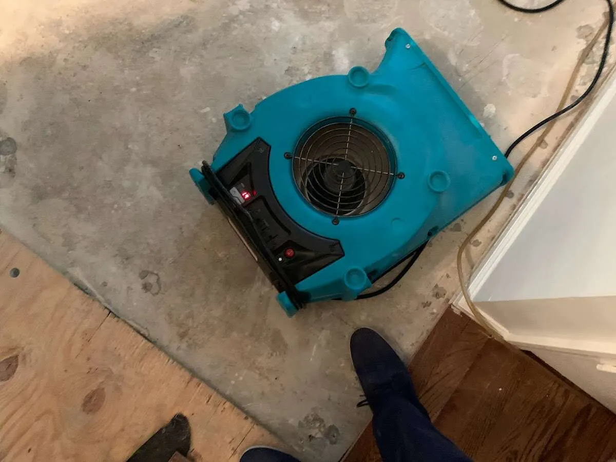 Air mover drying subfloor during Leak Detection & Repair in Crawfordsville